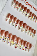Row of decorative false nails with rhinestones on a white background